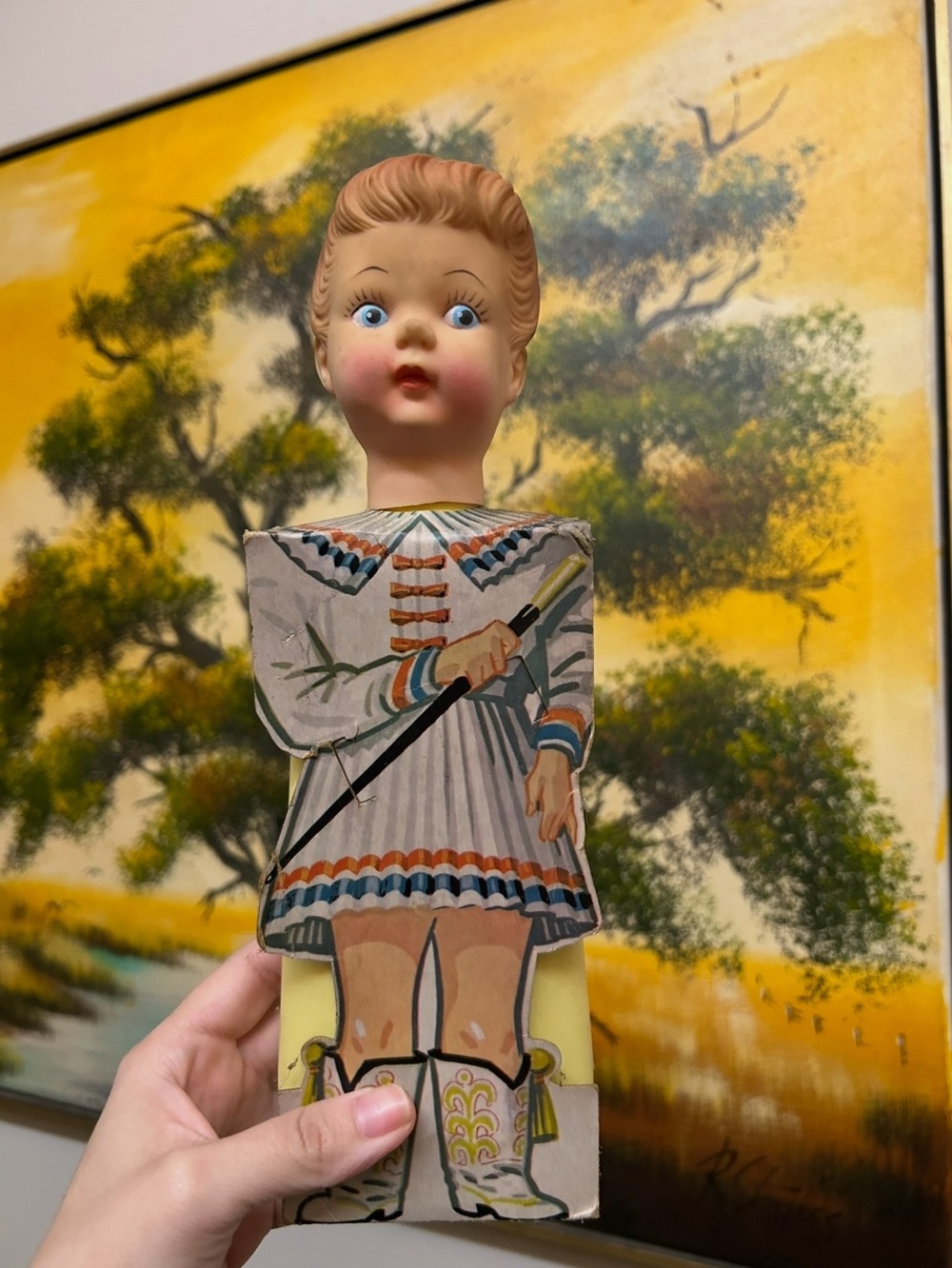 decorative piece featuring a doll head attached to a plastic dish soap bottle,